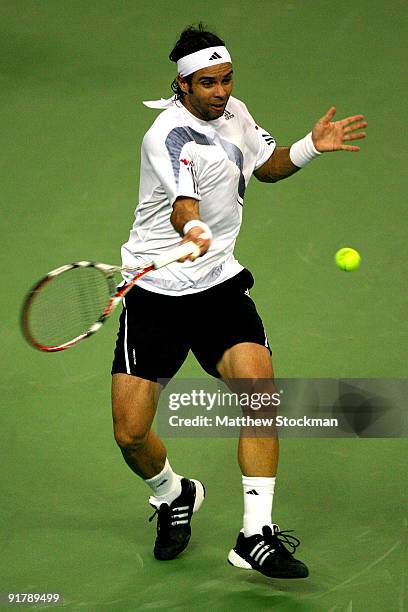 Fernando Gonzalez of Chile returns a shot to Mischa Zverev of Germany during day two of the 2009 Shanghai ATP Masters 1000 at Qi Zhong Tennis Centre...