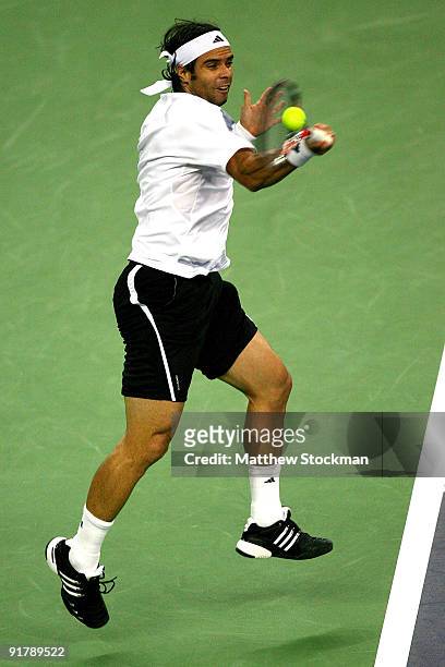 Fernando Gonzalez of Chile returns a shot to Mischa Zverev of Germany during day two of the 2009 Shanghai ATP Masters 1000 at Qi Zhong Tennis Centre...