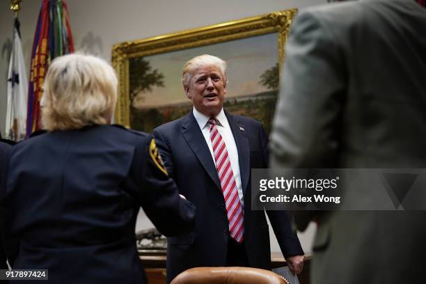 President Donald Trump greets representatives of the National Sheriffs Association in the Roosevelt Room of the White House February 13, 2018 in...
