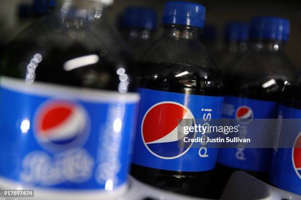 Bottles of Pepsi are displayed on a shelf at a convenience store on February 13, 2018 in San Anselmo, California. PepsiCo reported fourth quarter...