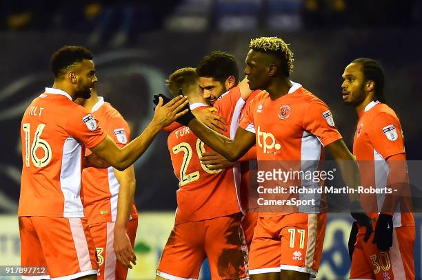 Blackpool's Kelvin Mellor celebrates scoring his side's second goal with his team-mates during the Sky Bet League One match between Wigan Athletic...
