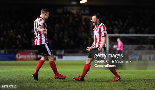 Lincoln City's Neal Eardley, right, celebrates scoring the opening goal with team-mate Harry Anderson during the Sky Bet League Two match between...