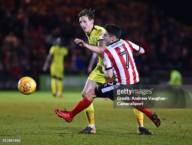 Lincoln City's Tom Pett is fouled by Cheltenham Town's William Boyle during the Sky Bet League Two match between Lincoln City and Cheltenham Town at...