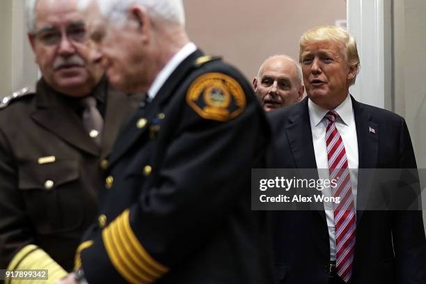 President Donald Trump , followed by White House Chief of Staff John Kelly , enters the Roosevelt Room for a meeting with representatives of the...