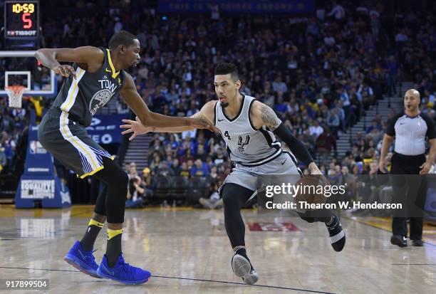 Danny Green of the San Antonio Spurs dribbles the ball while guarded by Kevin Durant of the Golden State Warriors during an NBA basketball game at...