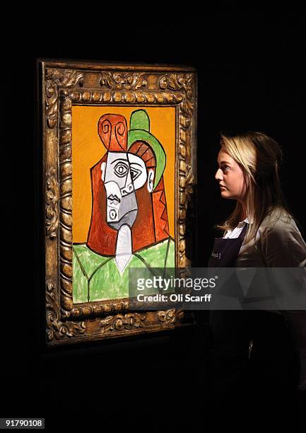 Gallery assistant for Sotheby's auction house views a painting by Pablo Picasso entitled 'Tete de Femme au Chapeau Vert' on October 12, 2009 in...