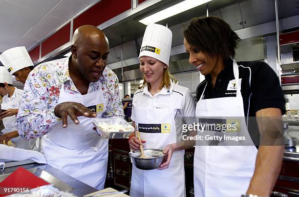 Young athlete Hannah Brooks in the kitchen with Dame Kelly Holmes and Ainsley Harriott during the Aviva On Camp with Kelly Cookery Get-Together on...