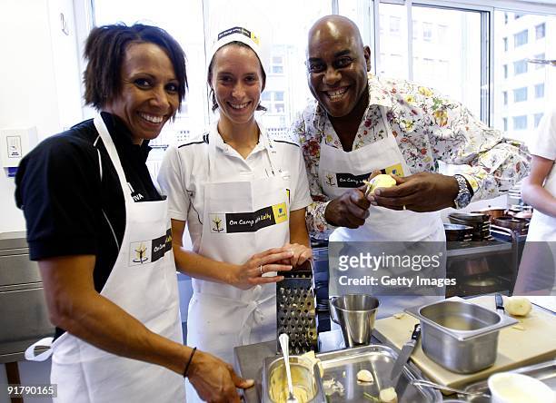 Young athlete Nikki Maddick in the kitchen with Dame Kelly Holmes and Ainsley Harriott during the Aviva On Camp with Kelly Cookery Get-Together on...