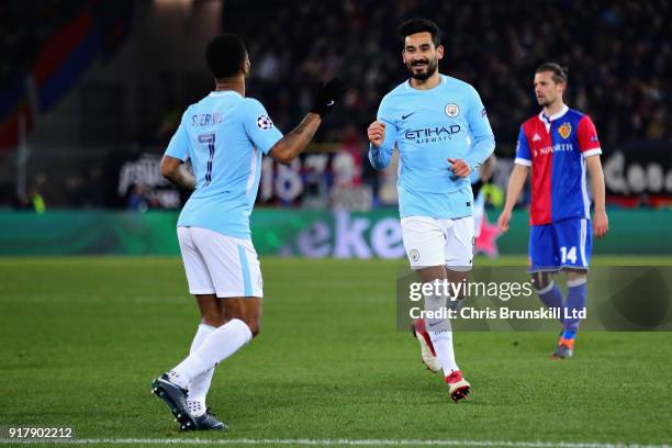Ilkay Gundogan of Manchester City celebrates with teammate Raheem Sterling after scoring his sides fourth goal during the UEFA Champions League Round...
