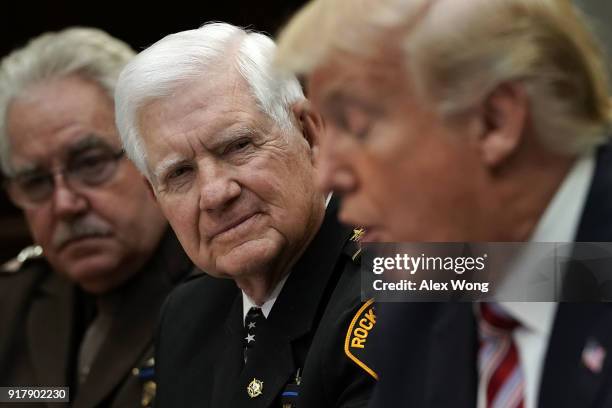 President Donald Trump speaks as President of the National Sheriffs Association Harold Eavenson of Rockwall County Sheriff's Office in Texas looks on...