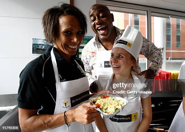 Young athlete Charlotte Purdue in the kitchen with Dame Kelly Holmes and Ainsley Harriott during the Aviva On Camp with Kelly Cookery Get-Together on...