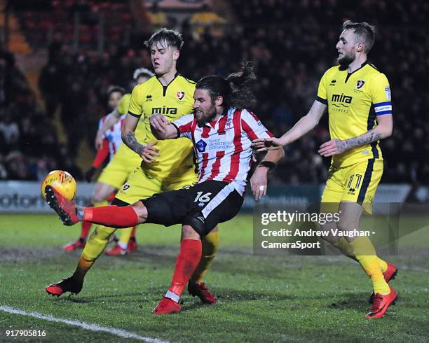 Lincoln City's Michael Bostwick vies for possession with Cheltenham Town's Joe Rodon, left and Cheltenham Town's Carl Winchester during the Sky Bet...