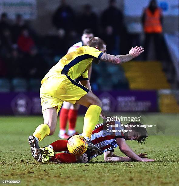 Lincoln City's Alex Woodyard vies for possession with Cheltenham Town's Harry Pell during the Sky Bet League Two match between Lincoln City and...