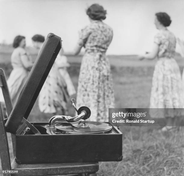 Members of Eastgate Women's Institute practising country dancing to a gramophone in the fields of Weardale, County Durham, 27th June 1953. Original...