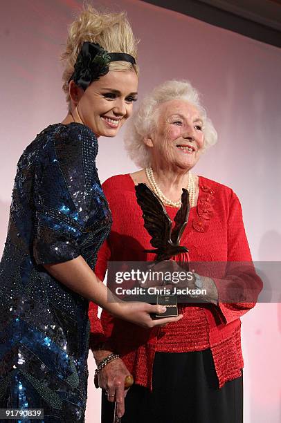 Singer Katherine Jenkins presents Dame Vera Lynn with her award as they attend the Women of the Year Lunch at Intercontinental Hotel on October 12,...