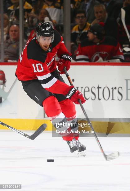Jimmy Hayes of the New Jersey Devils plays the puck against the Boston Bruins during the game at Prudential Center on February 11, 2018 in Newark,...