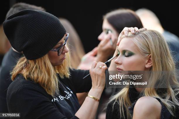 Model prepares backstage for Naeem Khan during New York Fashion Week: The Shows at Gallery I at Spring Studios on February 13, 2018 in New York City.