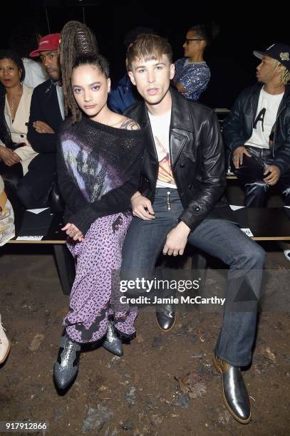 Actors Sasha Lane and Tommy Dorfman attend the Coach 1941 front row during New York Fashion Week at Basketball City on February 13, 2018 in New York...