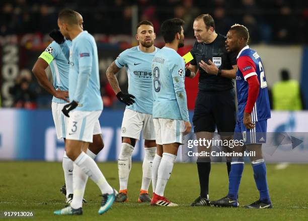 Referee Jonas Eriksson speak to Ilkay Gundogan of Manchester City and Geoffroy Serey Die of FC Basel during the UEFA Champions League Round of 16...