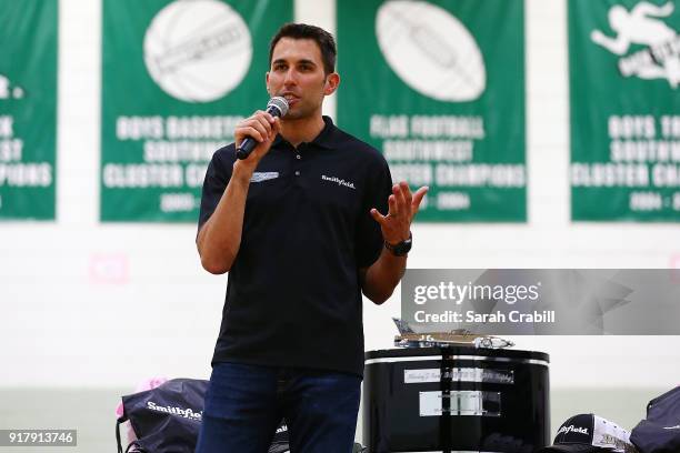 Aric Almirola, driver of the Smithfield Ford Fusion for Stewart-Haas Racing in the Monster Energy NASCAR Cup Series, speaks to honor-roll students at...