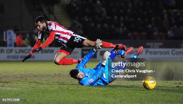 Cheltenham Town's Scott Flinders saves at the feet of Lincoln City's Matt Green during the Sky Bet League Two match between Lincoln City and...