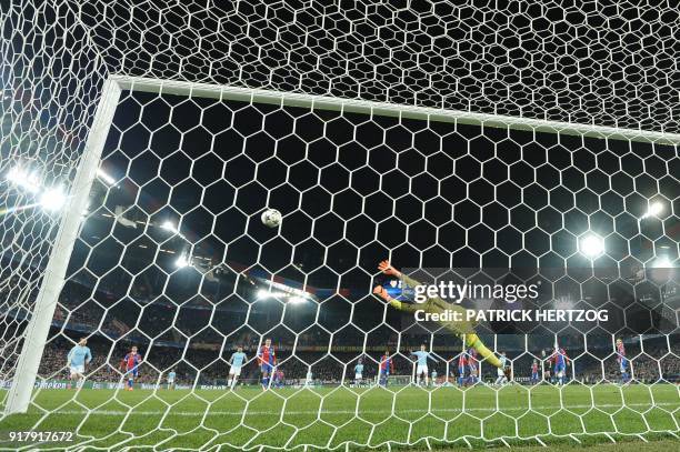 Basel's Czech goalkeeper Tomas Vaclik dives and takes a fourth goal scored by Manchester City's German midfielder Ilkay Gundogan during the UEFA...