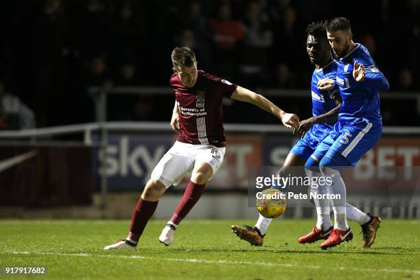 Chris Long of Northampton Town attempts to control the ball watched by Max Ehmer and Gabriel Zakuani of Gillingham during the Sky Bet League One...