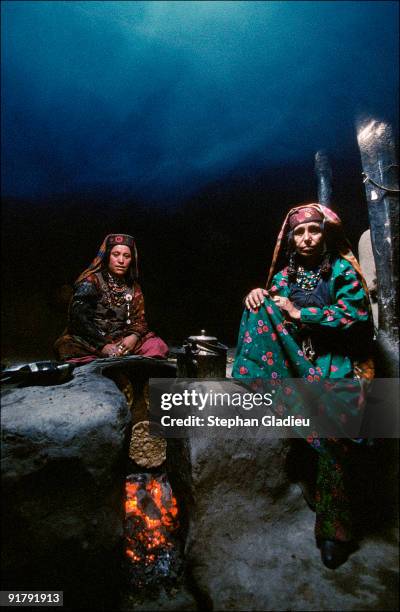 In Issik, at 3300m, women stay in the kitchen, far away from the male foreigners. They are cooking nan bread in the tandoor , and preparing tea with...