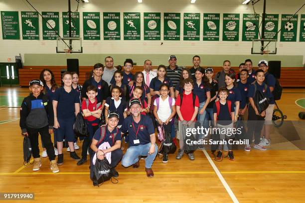 Aric Almirola, driver of the Smithfield Ford Fusion for Stewart-Haas Racing in the Monster Energy NASCAR Cup Series, and honor-roll students pose for...