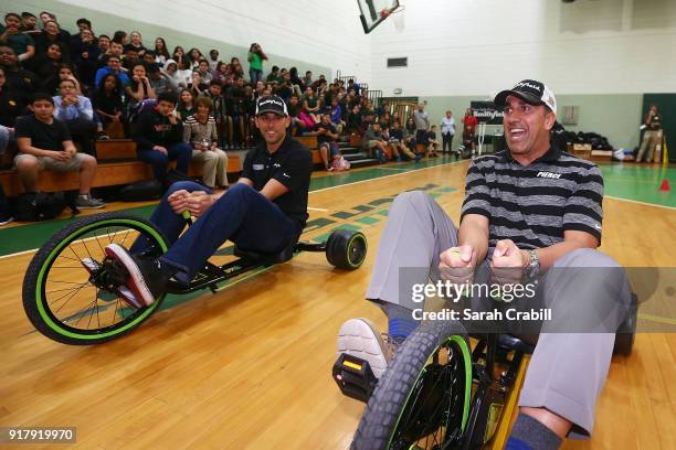 Aric Almirola, driver of the Smithfield Ford Fusion for Stewart-Haas Racing in the Monster Energy NASCAR Cup Series, participates in a tricycle race...