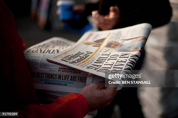 London Evening Standard employee distributes free copies to commuters in central London on October 12, 2009. London's Evening Standard on October 12,...