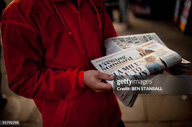 London Evening Standard employee distributes free copies to commuters in central London on October 12, 2009. London's Evening Standard on October 12,...