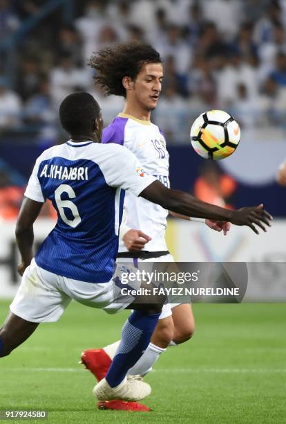 Al Hilal's Abdulmalek Al-Khaibri fights for the ball with Al Ain's Mohammed Abdulrahman during the AFC Champions League group stage football match...