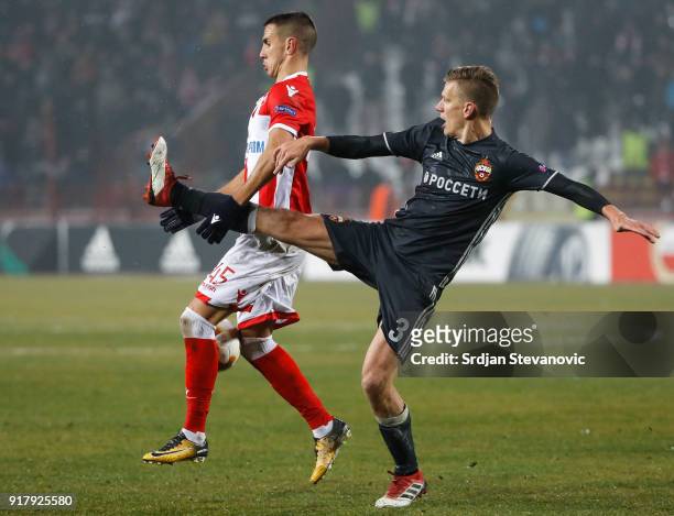 Aleksandar Pesic of Crvena Zvezda is challenged by Pontus Wernbloom of CSKA Moscow during the UEFA Europa League Round of 32 match between Crvena...