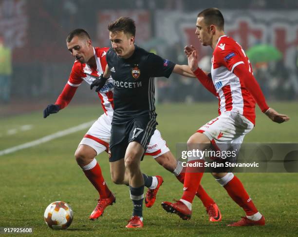Aleksandr Golovin of CSKA Moscow in action against Nenad Krsticic and Milan Rodic of Crvena Zvezda during the UEFA Europa League Round of 32 match...