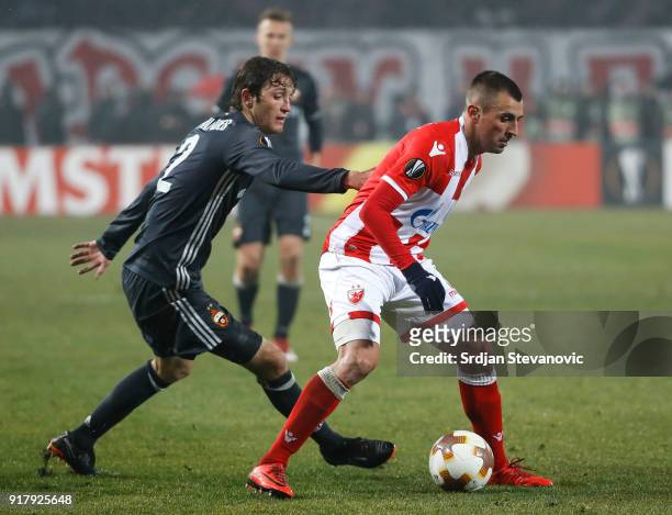 Nenad Krsticic of Crvena Zvezda in action against Mario Fernandes of CSKA Moscow during the UEFA Europa League Round of 32 match between Crvena...