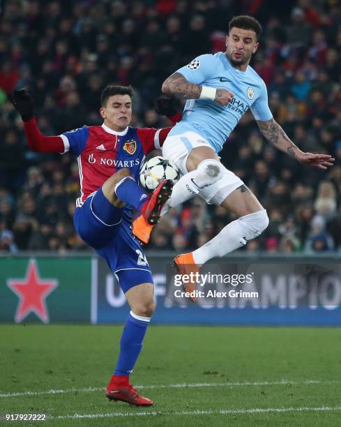 Mohamed Elyounoussi of Basel is challenged by Kyle Walker of Manchester during the UEFA Champions League Round of 16 First Leg match between FC Basel...