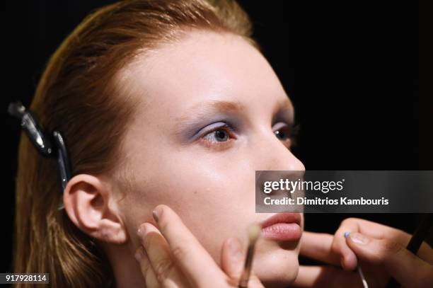 Model prepares backstage for BOSS Womenswear during New York Fashion Week at Cedar Lake on February 13, 2018 in New York City.