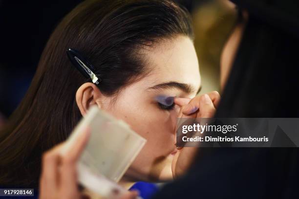 Model prepares backstage for BOSS Womenswear during New York Fashion Week at Cedar Lake on February 13, 2018 in New York City.