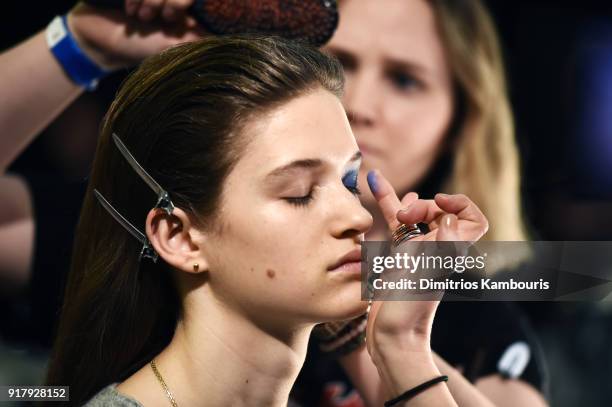 Model prepares backstage for BOSS Womenswear during New York Fashion Week at Cedar Lake on February 13, 2018 in New York City.