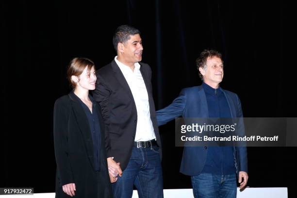 Autor of the Piece, Rachid Benzine standing between actors of the Piece; Lou de Laage and Charles Berling acknowledge the applause of the audience at...