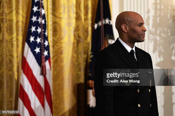 Surgeon General Jerome Adams listens during a reception in the East Room of the White House February 13, 2018 in Washington, DC. President Donald...