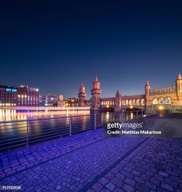 oberbaumbruecke berlin night view with star sky and motion dynamic ship - oberbaumbruecke stock pictures, royalty-free photos & images