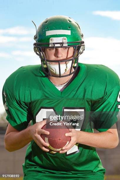 high school  or university american football player playing in field - quarterback stock pictures, royalty-free photos & images