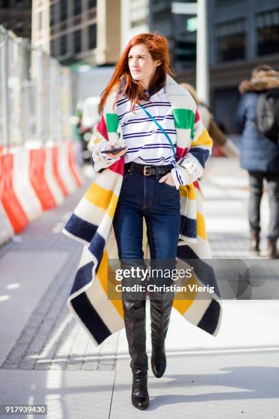 Taylor Tomasi Hill wearing striped coat, overknee boots, navy denim jeans seen outside Gabriela Hearst on February 13, 2018 in New York City.