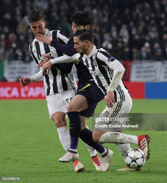 Heung-Min Son of Tottenham Hotspur competes for the ball with Mattia De Sciglio and Rodrigo Bentancur of Juventus FC during the UEFA Champions League...