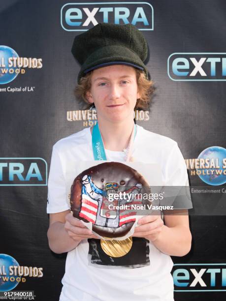 Red Gerard holds up a donut with an image of himself at "Extra" at Universal Studios Hollywood on February 13, 2018 in Universal City, California.