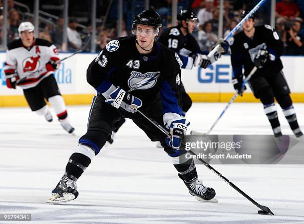 James Wright of the Tampa Bay Lightning shoots the puck against the New Jersey Devils at the St. Pete Times Forum on October 8, 2009 in Tampa,...