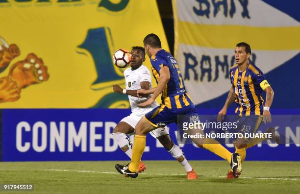 Ecuador's Deportivo Cuenca player Abel Araujo vies for the ball with Ruben Monges of Paraguay's Sportivo Luqueno during their Copa Sudamericana...