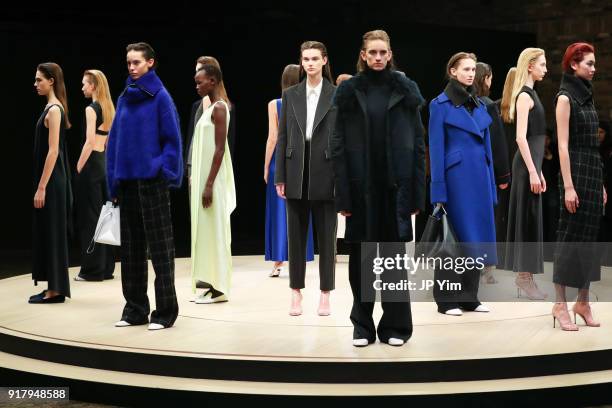 Models pose during BOSS Womenswear Gallery Collection During New York Fashion Week Mens' at Cedar Lake on February 13, 2018 in New York City.